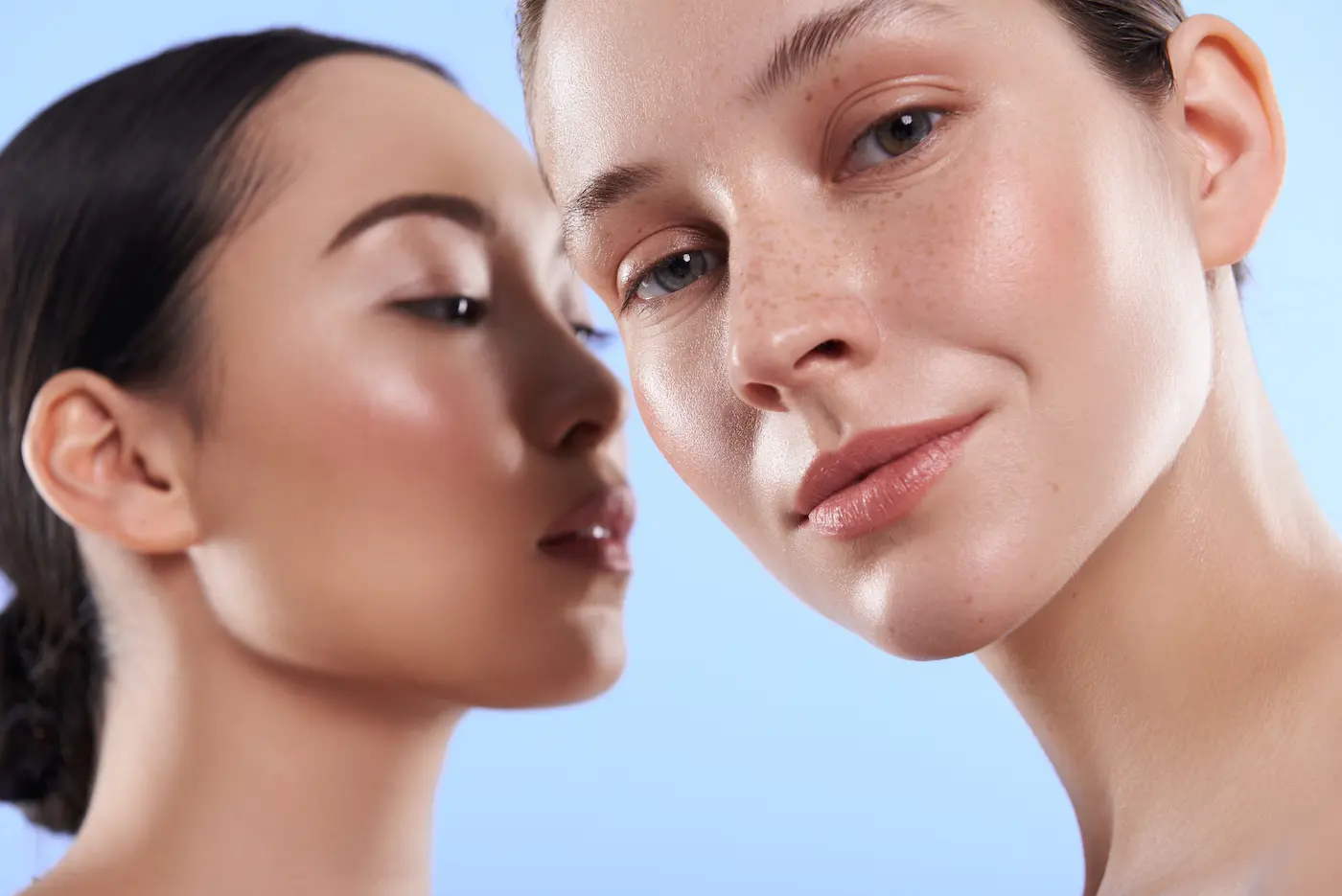 Two women with different skin tones, highlighting inclusive treatment capability across diverse skin types with Sono Veritas technology